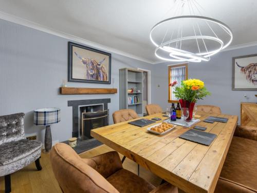 a dining room with a wooden table and chairs at Holiday Home Birnam by Interhome in Drumnadrochit