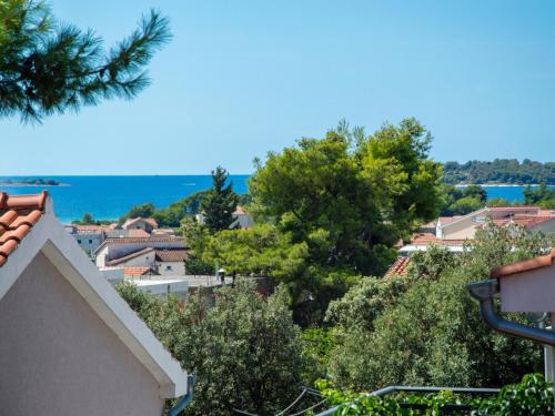 a view of a city with trees and the ocean at Holiday Home Gabi by Interhome in Brodarica