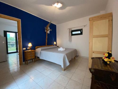 a bedroom with a bed and a cross on the wall at Apartment Green House by Interhome in La Caletta