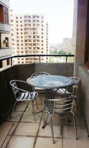 a table and two chairs on a balcony at New Build Apartment On Argishti Street in Yerevan