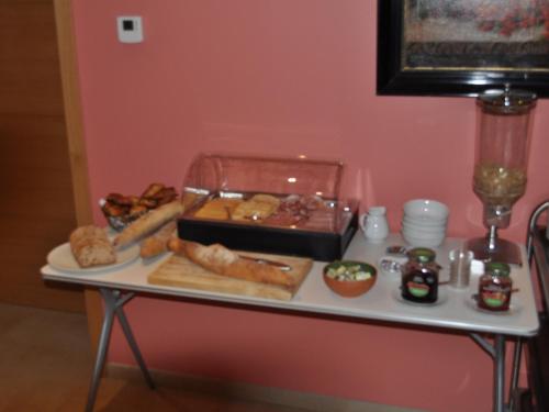 a table with a tray of food on it at Hôtel - Ferme du Château d'Ahin in Huy