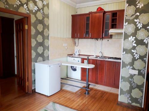 a kitchen with a white refrigerator and a table at New Build Apartment On Argishti Street in Yerevan