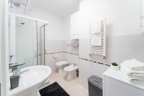 a white bathroom with a sink and a toilet at Central 700 square Fructus plaza - Eva apartment in Timişoara