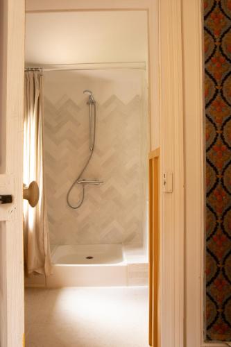 une salle de bain avec une douche avec un rideau de douche dans l'établissement La Maison Maroc, à Les Dubois