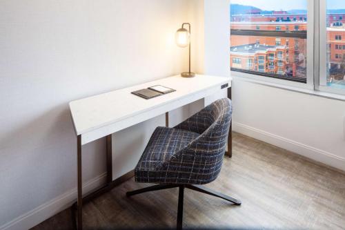 a desk with a chair next to a window at Hyatt Regency Morristown in Morristown
