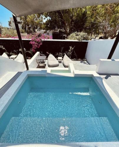 a small swimming pool in a backyard with at Santa Irina Luxury Sunny Lofts in Perivolos
