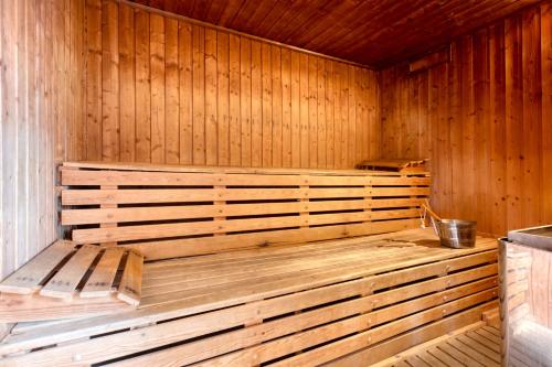an empty wooden sauna with a bucket in it at Martin's Brussels EU in Brussels