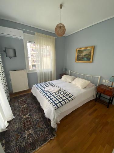 a bedroom with a bed and a rug at Feel Home in Volos