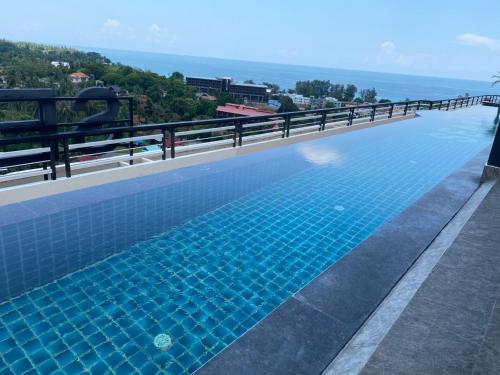 a swimming pool on the roof of a building at Phuket Condominium Karon beach in Karon Beach