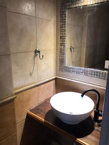 a bathroom with a white sink on a wooden counter at Dpto Pque in Azul