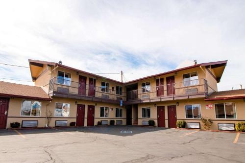 a large building with balconies and a parking lot at Quality Inn Bishop near Mammoth in Bishop