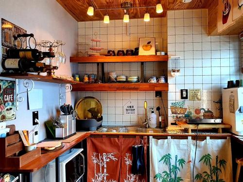 a kitchen with a sink and a counter top at Leehakjang guesthouse in Mokpo