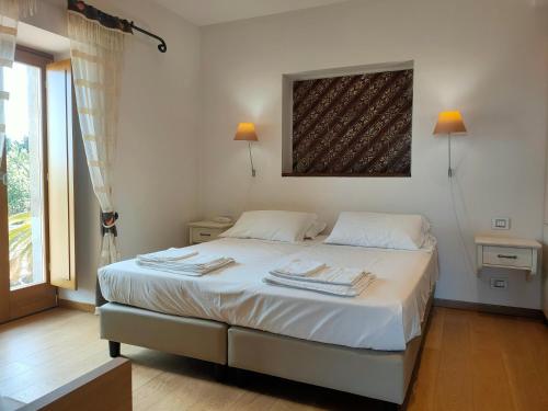 ein Schlafzimmer mit einem Bett mit zwei Handtüchern darauf in der Unterkunft Alimunera in CastellʼUmberto