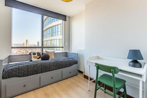 a bedroom with a bed and a desk and a window at Charming Flat with Gorgeous City View in Atasehir in Istanbul