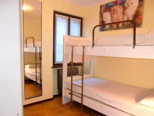 Habitación con 2 literas y espejo. en Stunning holiday home in Molina di Ledro near lake, en Molina di Ledro