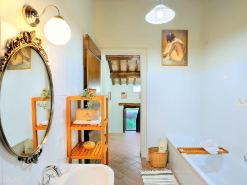 a bathroom with a sink and a mirror at Charming Villa in Monte San Martino with Swimming Pool in Monte San Martino