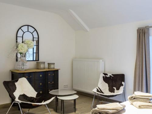 a living room with two chairs and a table at Charming Mill in Gedinne in Vencimont