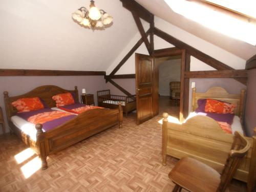 a bedroom with two beds and a chandelier at Spacious gîte for 6 persons in Hanviller, Mosel in Hanviller