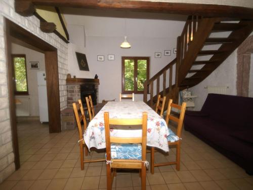 a dining room with a table and some chairs at Forest Retreat in Vosges in Hanviller