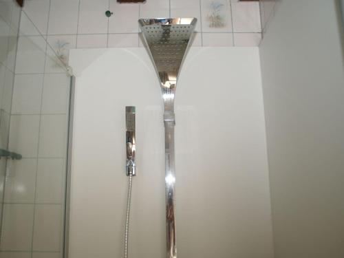 a shower in a bathroom with white tiles at Spacious gîte for 6 persons in Hanviller, Mosel in Hanviller