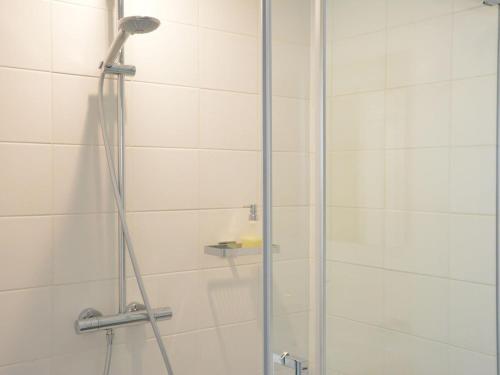 a shower with a glass door in a bathroom at Cozy Holiday Home in Gedinne near Forest in Vencimont
