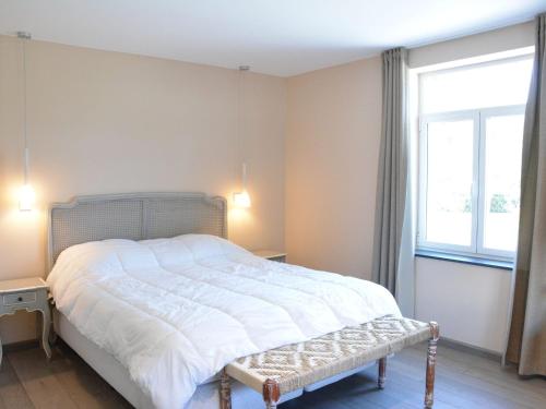 a bedroom with a large bed and a window at Cozy Holiday Home in Gedinne near Forest in Vencimont