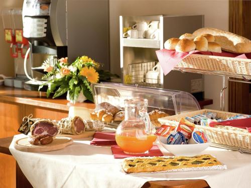 a table with bread and orange juice and food on it at Romantic Countryside Escape in Tordandrea
