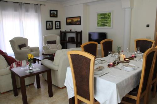 a dining room with a table and a living room at La Casa de Taramona, cerca de Puy Du Fou in Barcience