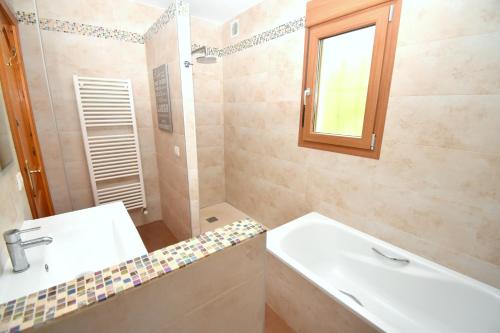 a bathroom with a sink and a tub and a shower at Casa Delfin in Jávea