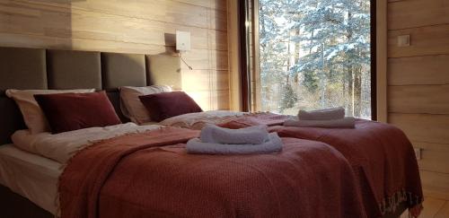 a bedroom with a large bed with towels on it at Dom Płociczno-Osiedle koło Suwałk in Płociczno