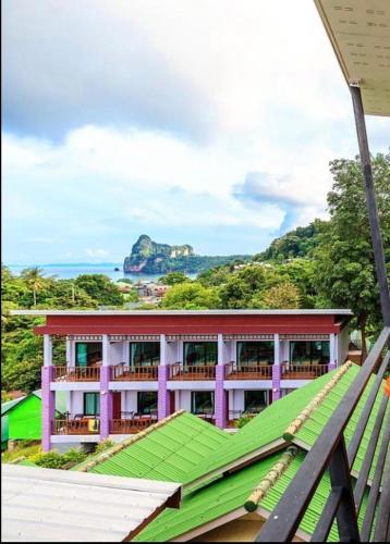 a building with a green roof with a view of the ocean at View Garden Resort in Phi Phi Don