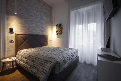 a bedroom with a bed and a window at Ferrari Suite in Campobasso