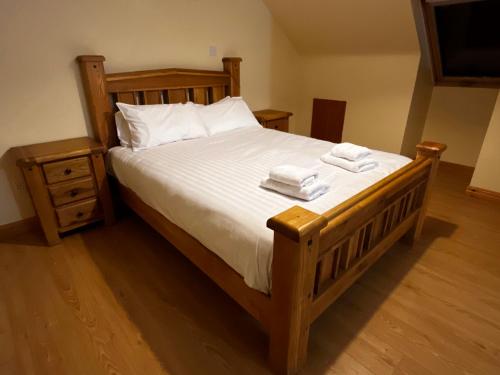 a bedroom with a bed with two towels on it at Ashdoon House in Donegal