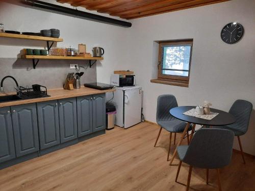 a kitchen with a table and chairs in a room at Vila Kamila in Tatranska Strba