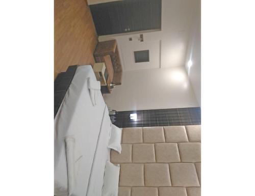 a bathroom with a sink and a tile floor at Hotel New Grand, Deoghar in Deoghar