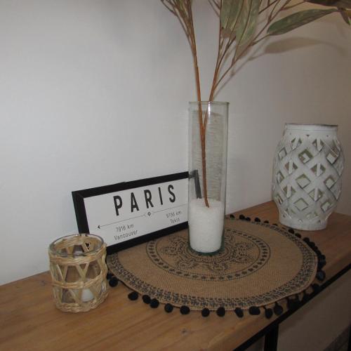 a table with a vase and a sign on it at Hotel Alta Mendoza in Mendoza