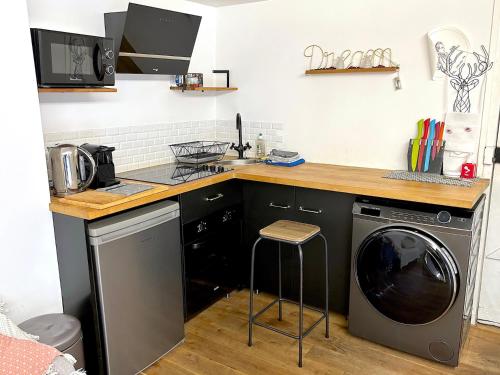 a kitchen with a sink and a washing machine at Loft Varenne in Paris