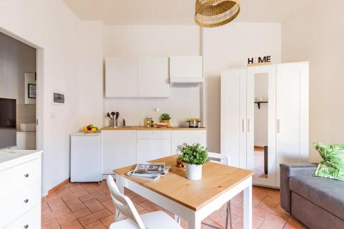 a living room with a table and a kitchen at Duomo Central Studio in Florence
