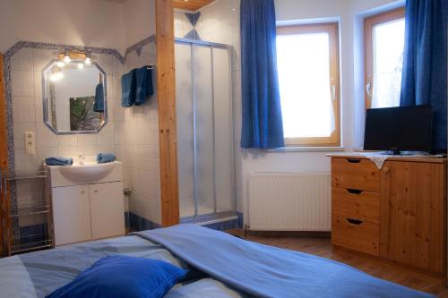 a bedroom with a bed and a sink and a mirror at Appartement Heidi by Schladmingurlaub in Ramsau am Dachstein