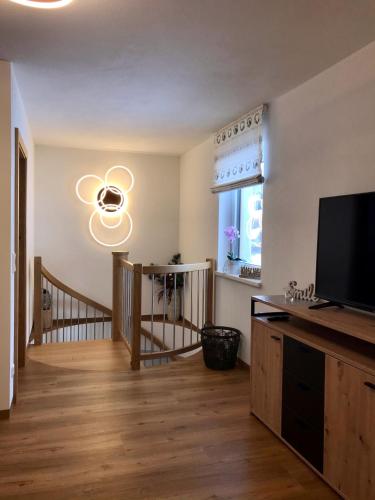 a living room with a flat screen tv next to a window at Bio Schartenhof in Sankt Johann im Pongau