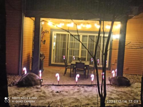 a house with flamingos in the yard at night at luxurious Mont tremblant 2bd 2bth in Mont-Tremblant
