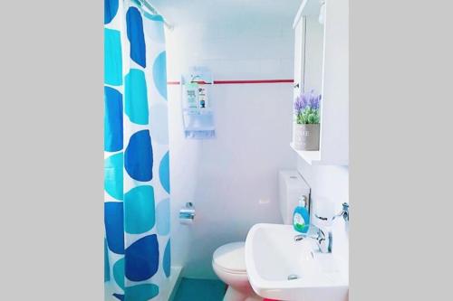 a bathroom with a white toilet and a sink at LEFKES Apartments Sidari in Sidari