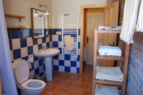 a bathroom with a sink and a toilet and a sink at La formigana in Soto y Amío