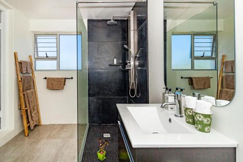 a bathroom with a sink and a shower at Morgen Guesthouse Somerset West in Somerset West