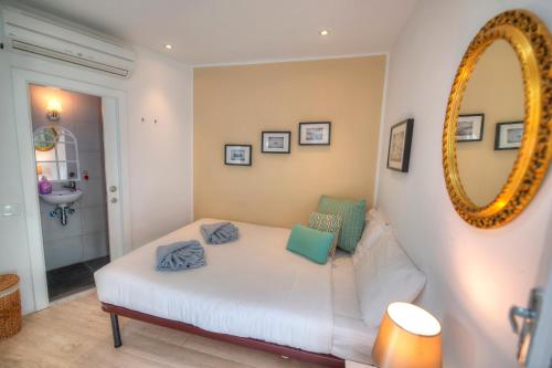 a living room with a white couch and a mirror at Casa Bartolo A Hidden Gem - Spacious Village Home EBAR1-1 in Lija