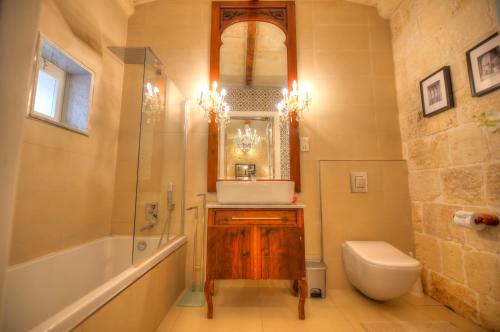 a bathroom with a sink and a tub and a toilet at Casa Bartolo A Hidden Gem - Spacious Village Home EBAR1-1 in Lija