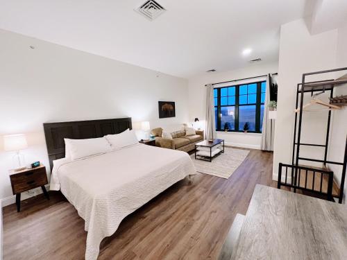 a white bedroom with a bed and a couch at Mountain Creek Resort at Appalachian Hotel - Pool & Hot Tub in Vernon Township