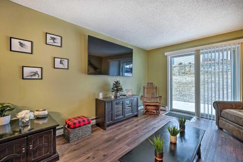 a living room with a couch and a table at Cozy Ski-InandSki-Out Condo on Magic Mountain in Londonderry
