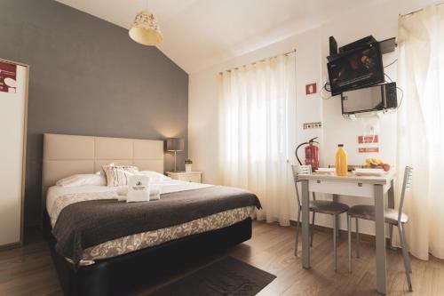 een slaapkamer met een bed, een tafel en een bureau bij Best Houses 04 - Loft in the Heart of Peniche in Peniche