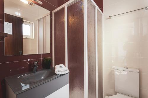 a bathroom with a sink and a toilet and a mirror at Best Houses 04 - Loft in the Heart of Peniche in Peniche